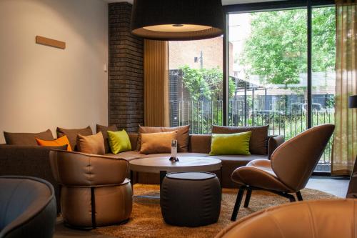 a living room with a couch and chairs at Wakeup Copenhagen - Borgergade in Copenhagen
