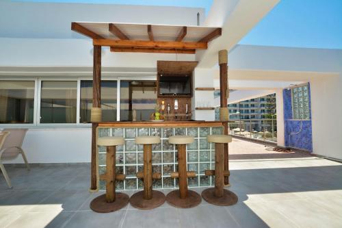 a kitchen with a bar with a view at Seafront Protaras Apartments in Protaras