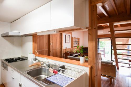a kitchen with a sink and a counter top at South Coast house in Yakushima