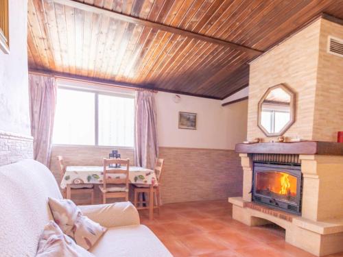 a living room with a fireplace and a table at Holiday Home Rural Cacin by Interhome in Cacin