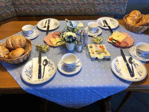 a table with a blue table cloth with food on it at Pension Millinger in Sankt Martin bei Lofer