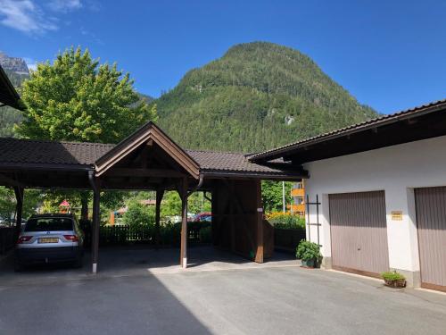 a car parked in a parking lot in front of a mountain at Pension Millinger in Sankt Martin bei Lofer