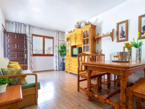 a living room with a wooden table and a dining room at Holiday Home Coquetó by Interhome in Riumar