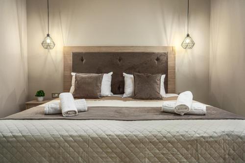 um quarto com uma cama grande e 2 almofadas em BlueWind Villa em Zakynthos Town