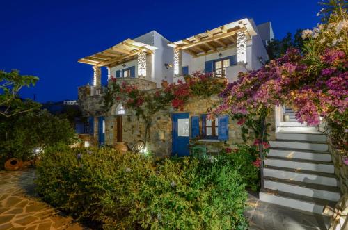a house with flowers on the side of it at Naxos Filoxenia Hotel in Galini