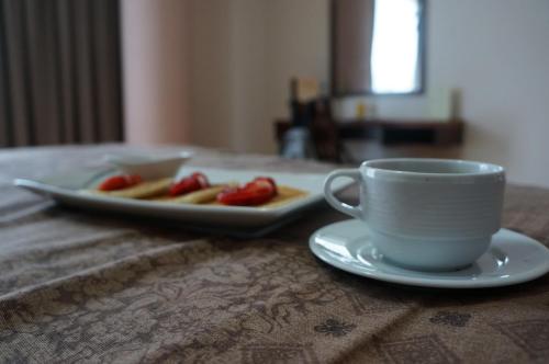 a table with a plate of food and a cup of coffee at Hotel Castropol in Mexico City
