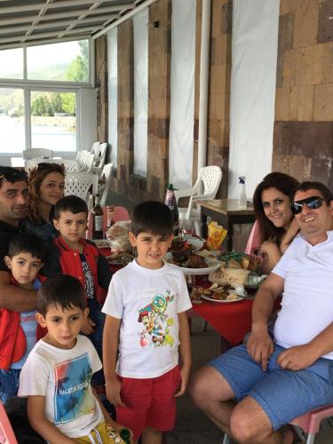 a group of people sitting around a table with food at EDEM SEVAN in Sevan