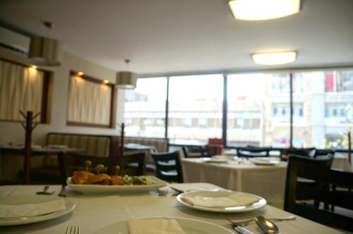 a dining room with a table with a plate of food at Hotel Castropol in Mexico City