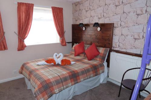 En eller flere senge i et værelse på The Rowan Hotel