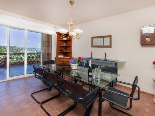a dining room with a glass table and chairs at Holiday Home Xarmada Cecilia by Interhome in Begur