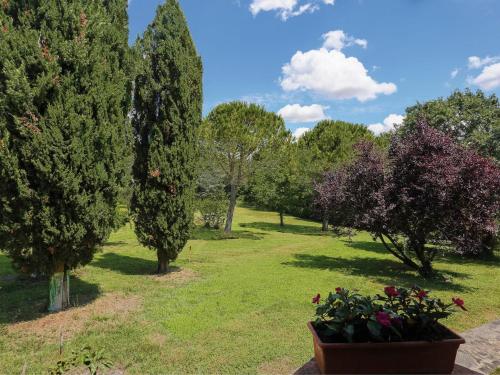 a park with trees and flowers in the grass at Apartment Il Contadino - TER102 by Interhome in Laiatico