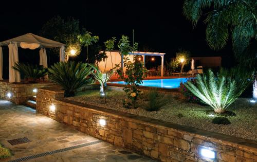 a backyard with a swimming pool at night at Cuore del Cilento Relais&Retreat in Castellabate