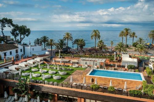 an aerial view of a resort with a swimming pool and the ocean at Rosamar & Spa 4*s in Lloret de Mar