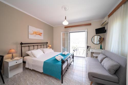 a bedroom with a bed and a couch at Pavlatos Apartments & Studios in Sami