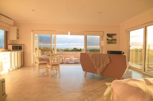 a kitchen and dining room with a table and chairs at Ocean Reef Vista in Perth