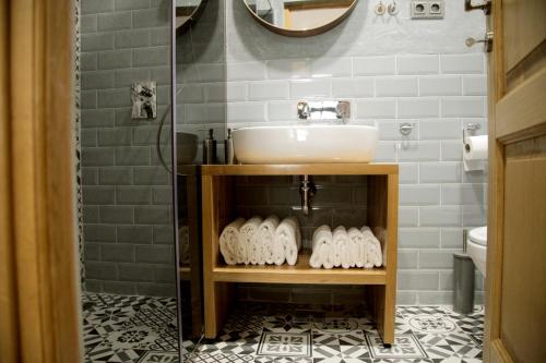 a bathroom with a sink and a mirror and a shower at Central Boutique Apartments in Sighişoara
