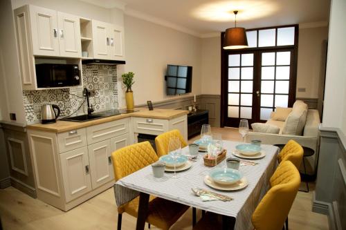 a kitchen and dining room with a table and chairs at Central Boutique Apartments in Sighişoara