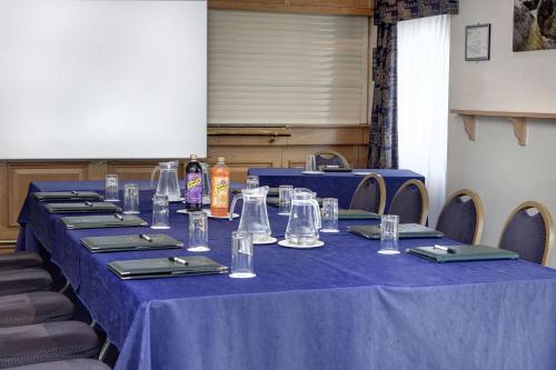 a long table with blue table cloths and empty glasses at Best Western Plus Bentley Hotel in Lincoln
