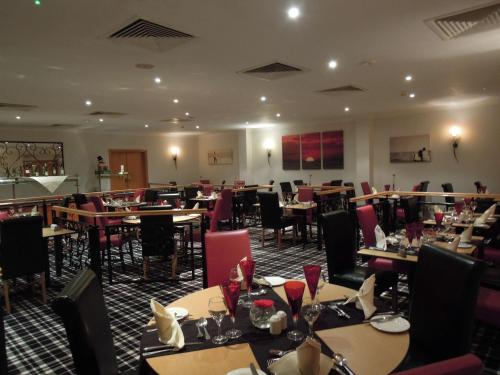a dining room filled with tables and chairs at Best Western Plus Bentley Hotel in Lincoln