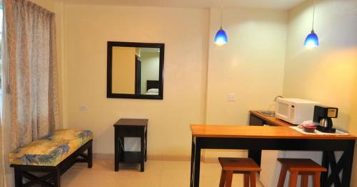 a room with a desk with a computer on it at Rainbow Hotel in Caye Caulker