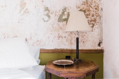 a lamp on a table next to a bed at The Bull Inn in Totnes