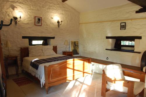 a bedroom with a bed in a room at Studio Gîte de Fontclairet in Champagne-Mouton