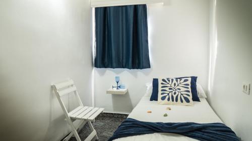 A bed or beds in a room at Pensión Playa