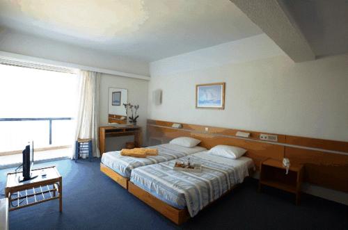 Ένα ή περισσότερα κρεβάτια σε δωμάτιο στο Apollon Suites