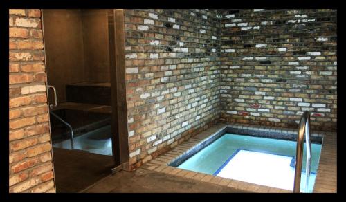 a brick building with a sink and a brick wall at Hotel Gaythering - Gay Hotel - All Adults Welcome in Miami Beach