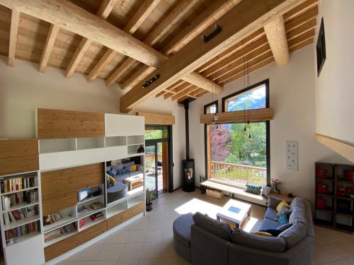 a living room with a couch and a large window at Chambres d'hôtes - B&B - Chalet Mountain Vibes in Les Houches