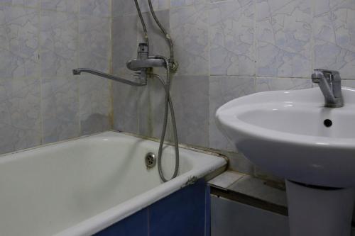 a bathroom with a bath tub and a sink at Apartments on Vostok 5/2 in Bishkek