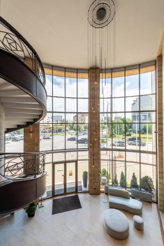 a large room with a large glass wall at Hotel VEGA Sofia in Sofia