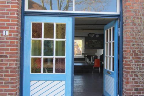a blue door leading into a brick building at Grosses und gemütliches Landhaus in Sankt Margarethen