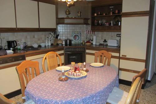 a kitchen with a table and chairs with a table and a table at Grosses und gemütliches Landhaus in Sankt Margarethen