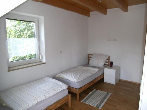 a room with two beds and a window at Ferienhaus Kettler II in Muhr amSee