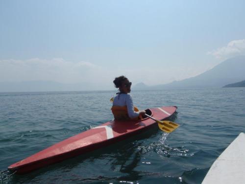 a woman sitting on a kayak in the water at Mikaso Hotel in San Pedro La Laguna