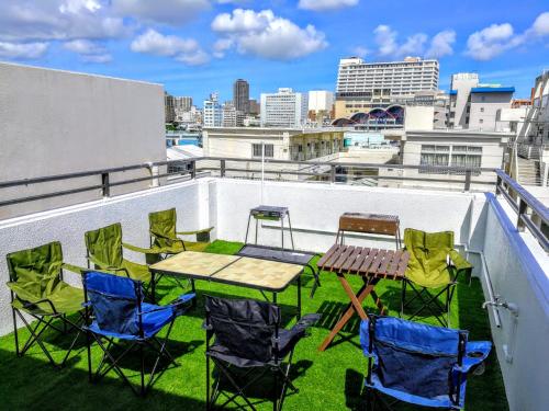 a patio with a table and chairs on a roof at NahaCentaral_10Beds7roomsHouse_190sqm_FreeParking in Naha