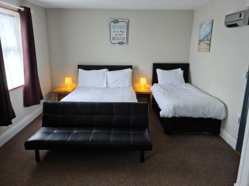 a hotel room with two beds and two lamps at The Royal Albion in Walton-on-the-Naze