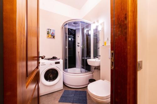 a bathroom with a toilet sink and a washing machine at Cozy Storie's AP, 47sqm, Renovated 2020, Free parking in Riga