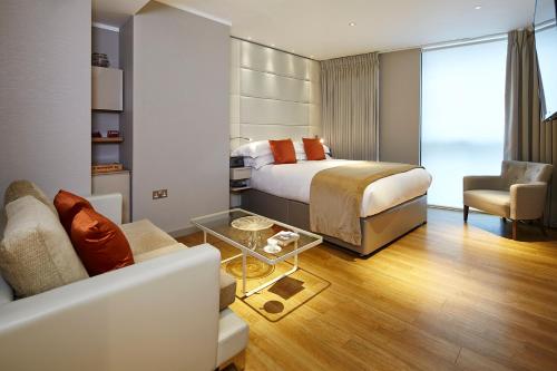 a bedroom with a bed and a living room at Cheval Three Quays at The Tower of London in London