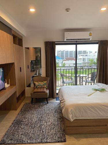 a hotel room with a bed and a balcony at Rose 'Lacasita Huahin in Hua Hin