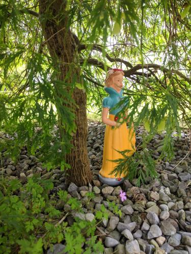 a statue of a woman standing next to a tree at Lough Gara Lodge Self Catering in Gorteen