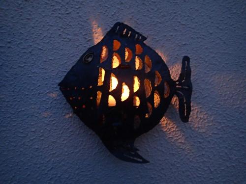 a fish shaped light on a wall at Lough Gara Lodge Self Catering in Gorteen