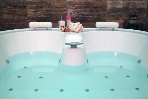 a person is sitting in a bath tub at Piccolo di Piazza di Spagna Suites in Rome