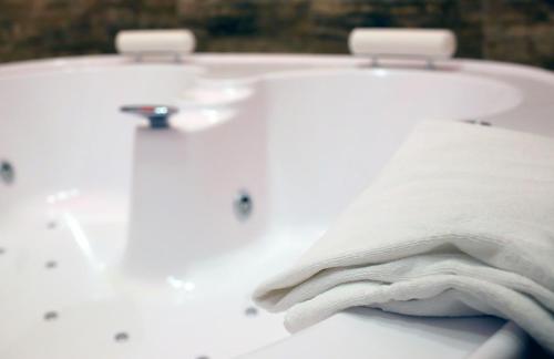 a close up of a white sink with a towel at Piccolo di Piazza di Spagna Suites in Rome