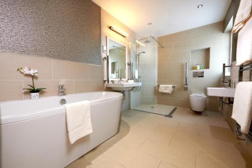 
a bathroom with a toilet, sink, and bathtub at Rufflets St Andrews in St. Andrews
