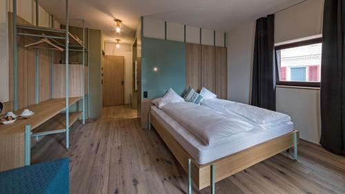 a bedroom with a large bed in a room at Hotel Villa Mayr Rooms & Suites in Brixen