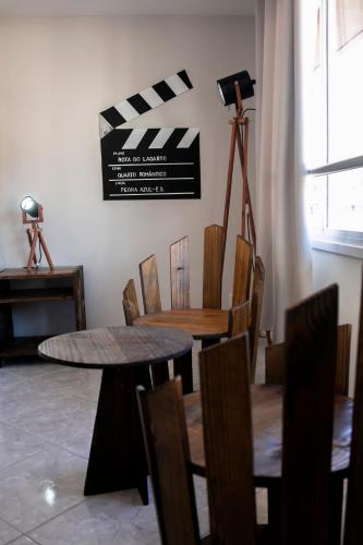 a dining room with a table and chairs and a camera at Pousada Rua de Lazer in Domingos Martins