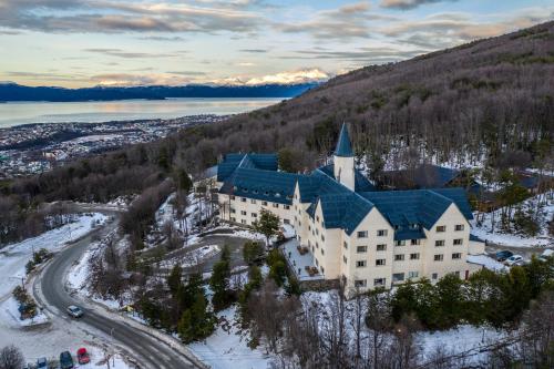 an aerial view of a building on a hill with snow at Las Hayas Ushuaia Resort in Ushuaia