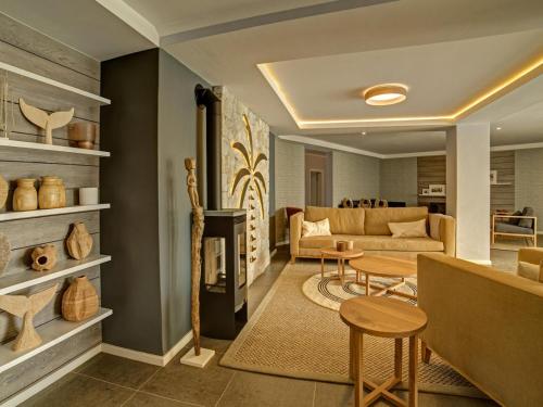 a living room with a couch and a table at Atlantic Garden Boutique Hotel in Swakopmund